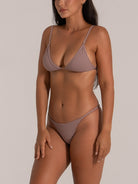 Side view of mauve bikini bottom with thin side straps and clean finish
