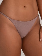 Detail view of mauve cheeky bikini bottom highlighting sleek side design