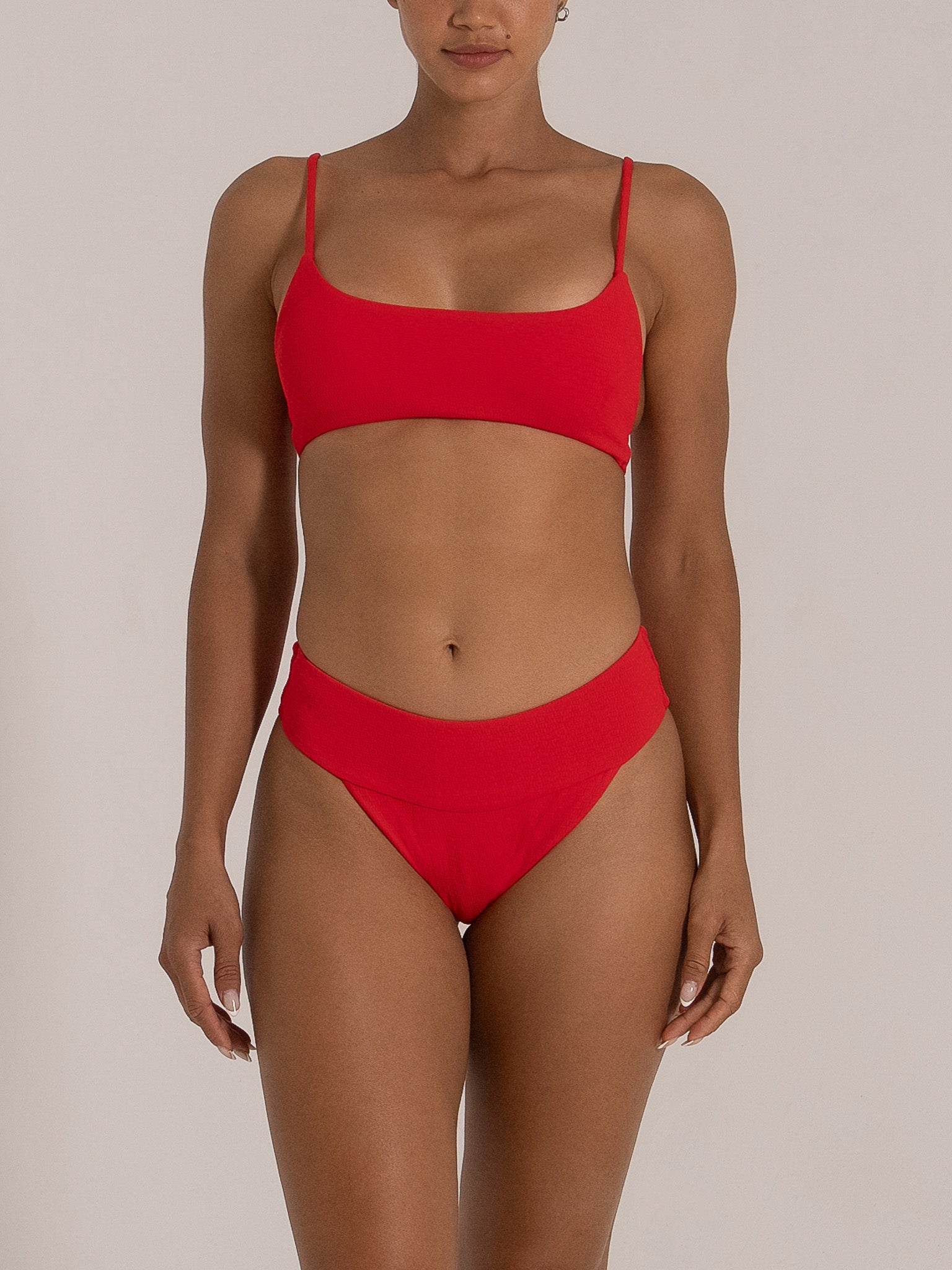 Red textured bikini bottom styled with matching red bralette top