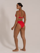 Side-back angle of red bikini set featuring square neck top and flattering high-cut bottom.