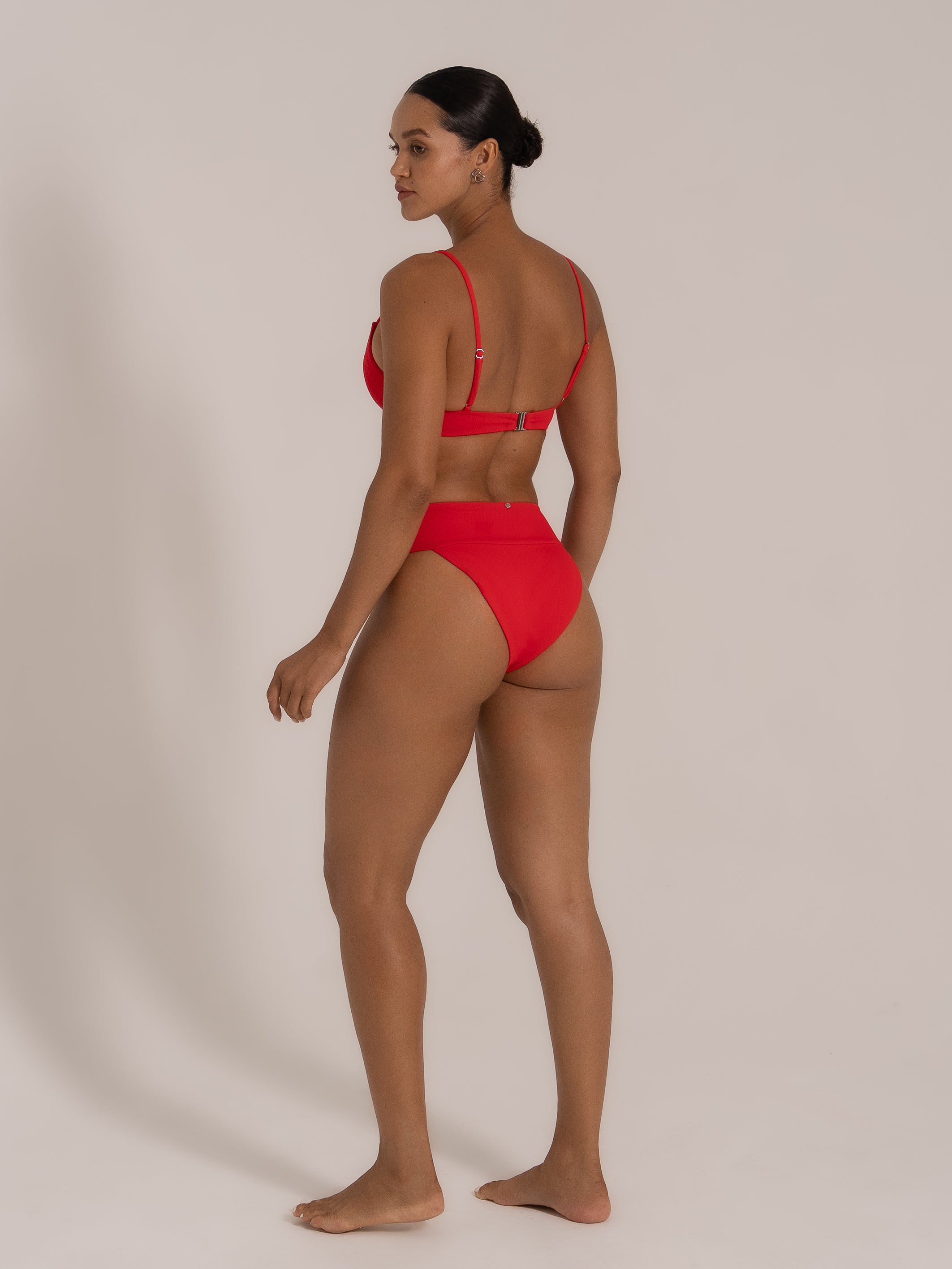 Side-back angle of red bikini set featuring square neck top and flattering high-cut bottom.