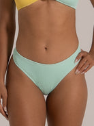 Close-up of front waist and fabric texture on mint green bikini bottom