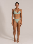 Front view of a woman modeling a mint green textured high-waist bikini set.