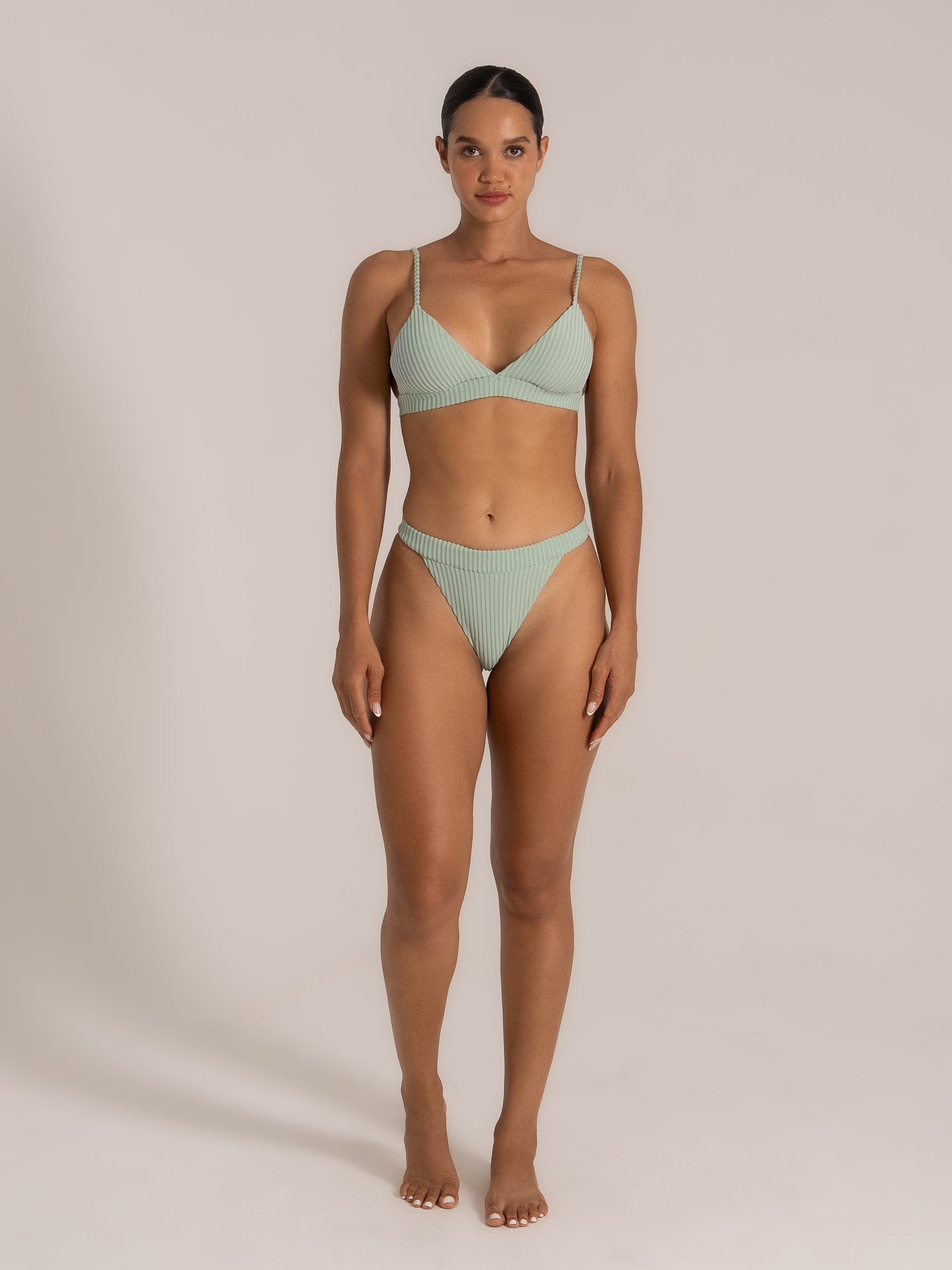 Front view of a woman modeling a mint green textured high-waist bikini set.