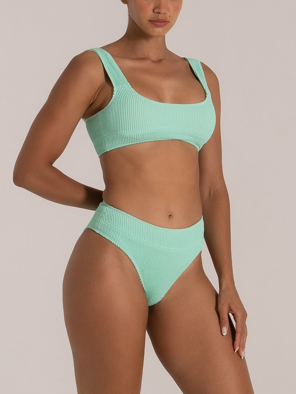 Side view of mint green high waist bikini bottom with full coverage and stretch fabric