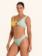 Minimal bikini bottom in mint green and mustard yellow with chic cut.