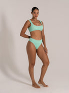 Angled front view of a mint green textured bikini set with scoop neckline and ribbed finish.