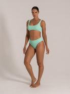 Front view of a mint green textured bikini set featuring wide shoulder straps and high-waisted bottom.