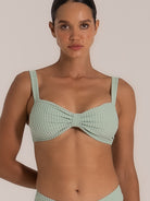 Close-up front view of mint green bow bikini top with ribbed fabric and thick shoulder straps