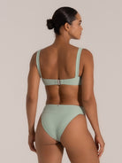 Back view of mint green ribbed bikini top with bow detail and wide straps