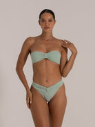 Front-facing view of model in mint green bandeau bikini set featuring ribbed texture and knotted front.