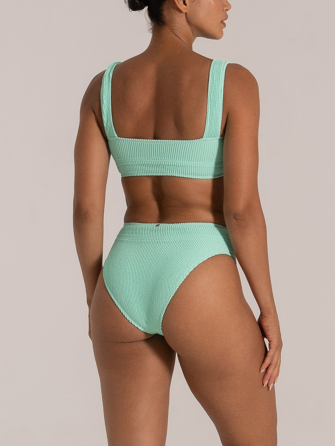  Mint green high rise bikini bottom shown from back side profile angle