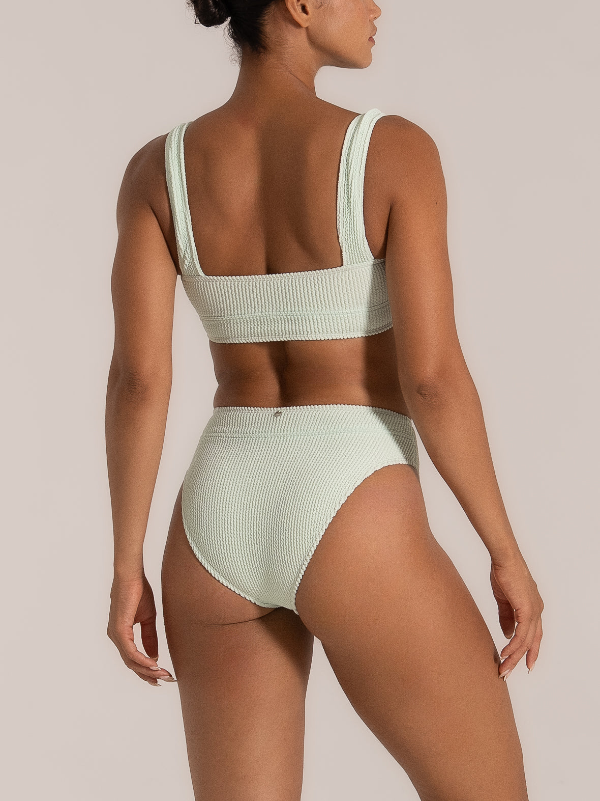 Back view of mint green high waist bikini bottom in textured fabric
