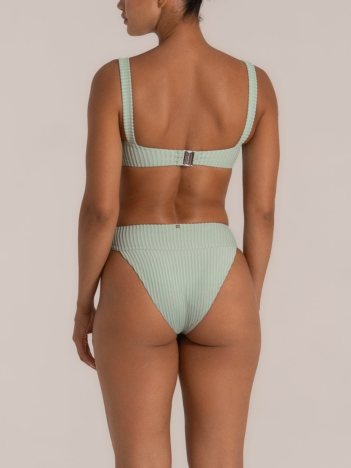 Back view of mint green ribbed high waisted bikini bottom with wide waistband