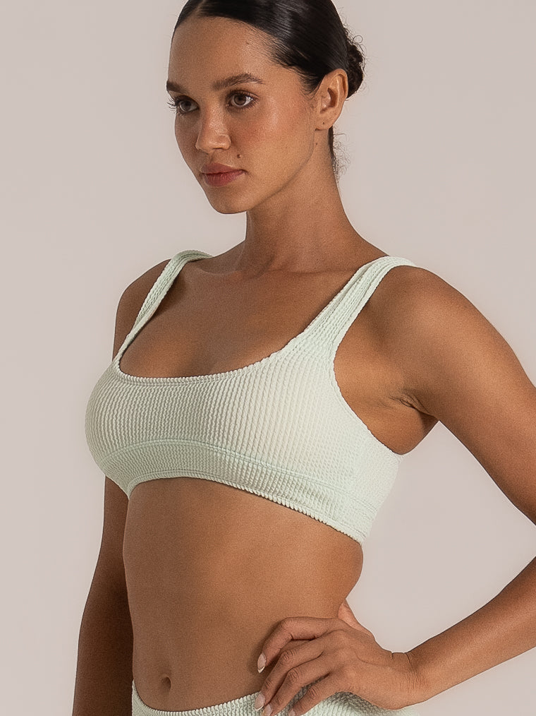 Side profile of mint green textured bikini top with supportive wide straps