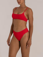 Side view of red high-rise bikini bottom on model