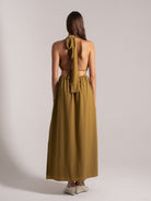 Back view of mustard yellow halter maxi dress