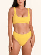 Mustard yellow bikini bottom with high waist design and textured fabric.