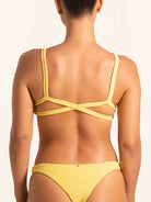 Back view of mustard yellow bikini top featuring cross back straps design.
