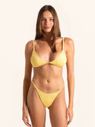 Front view of mustard yellow triangle bikini top with adjustable straps.