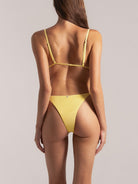 Back view of mustard yellow Brazilian bikini bottom with high-cut design and cheeky coverage
