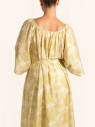Back view of mustard yellow floral maxi dress with loose fit