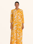 Front view of mustard yellow floral maxi dress with long sleeves and collar detail