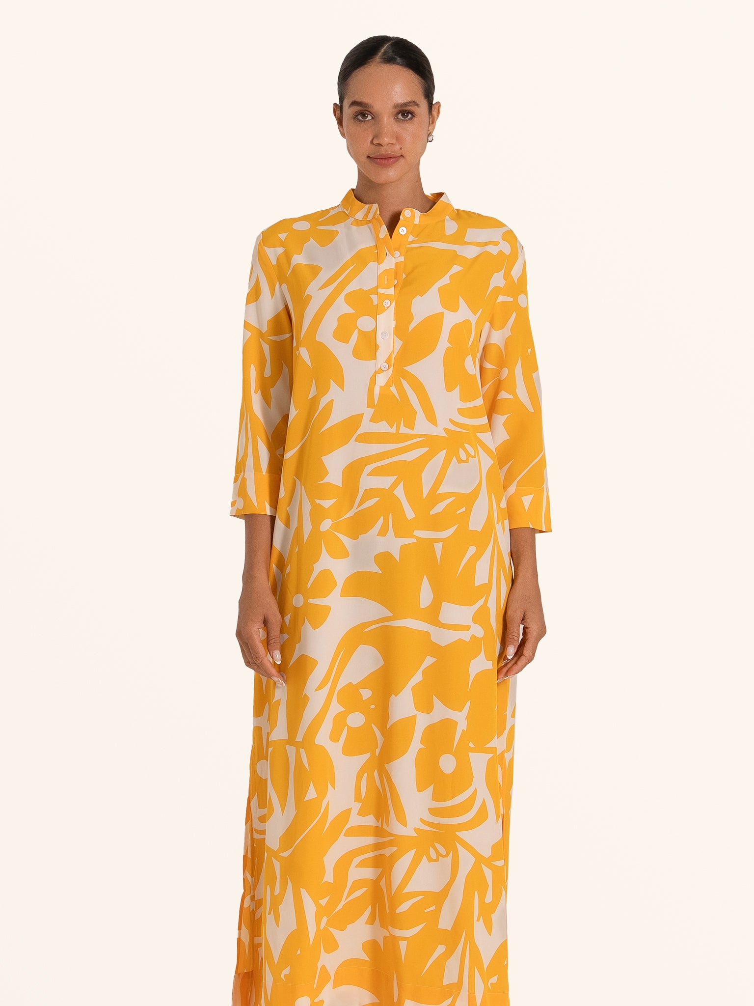 Front view of mustard yellow floral maxi dress with long sleeves and collar detail