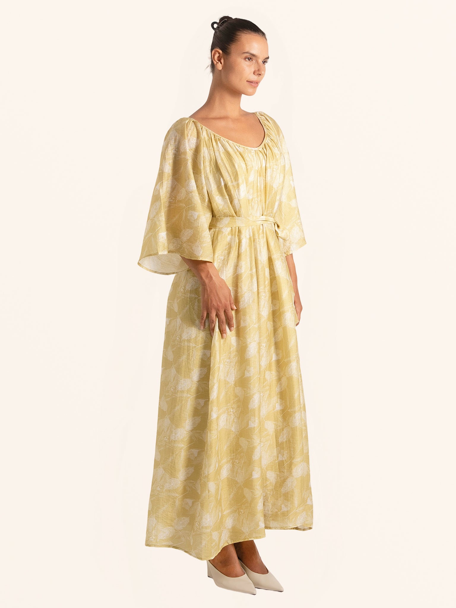Full body view of mustard yellow floral maxi dress with tied waist