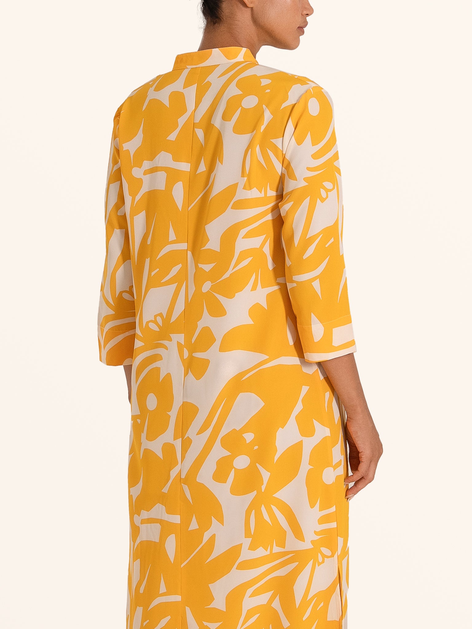 Back closeup of mustard yellow floral print maxi dress with long sleeves