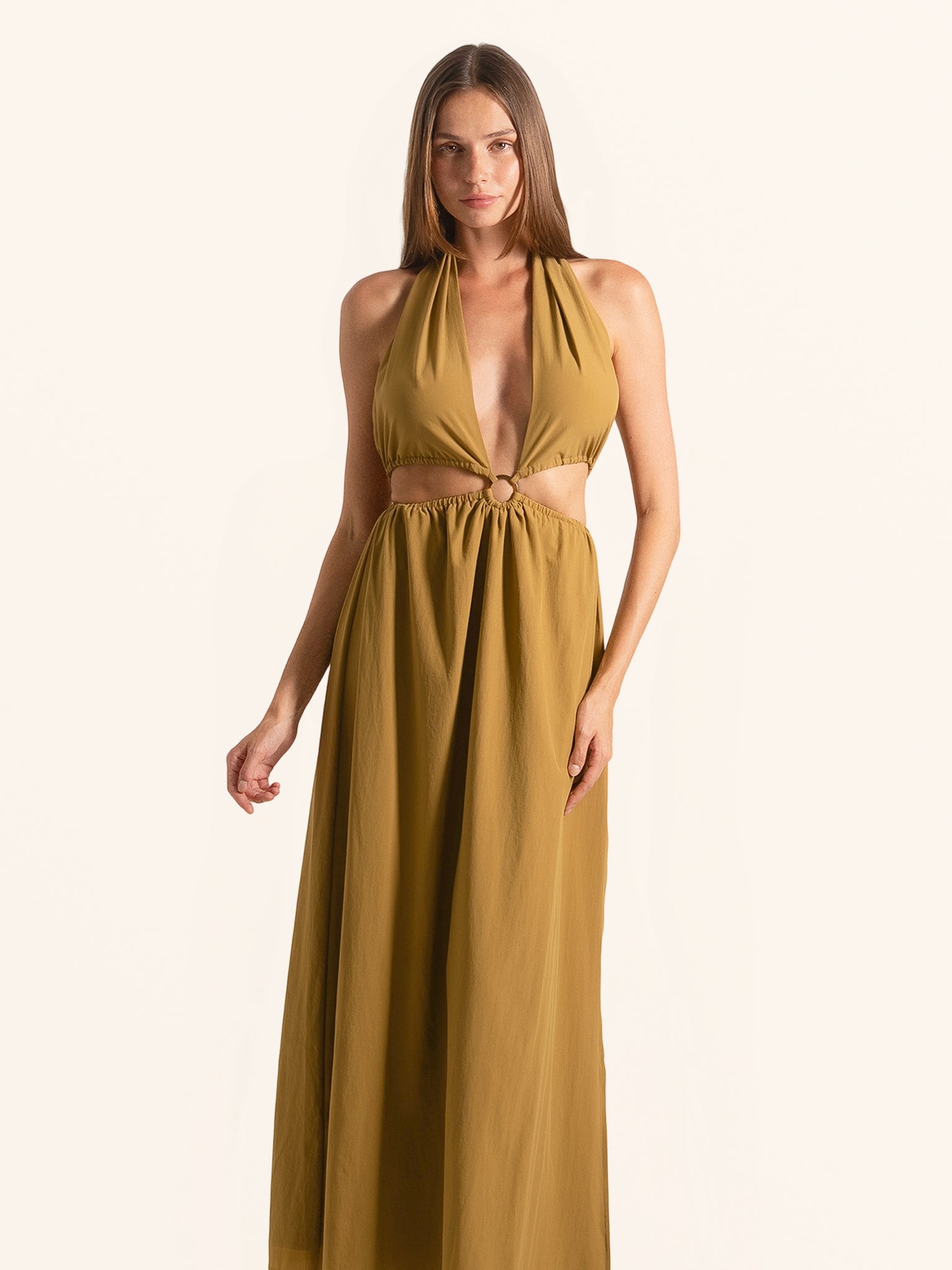 Front view of mustard yellow halter cut out maxi dress with ring detail