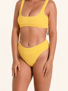 High rise bikini bottom in mustard yellow with full coverage and ribbed finish.