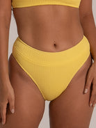 Close-up of mustard yellow high-waist bikini bottom with ribbed texture