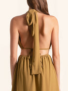 Back view of mustard yellow maxi dress with halter tie straps and open back