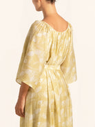 Side profile of mustard yellow maxi dress with wide sleeves