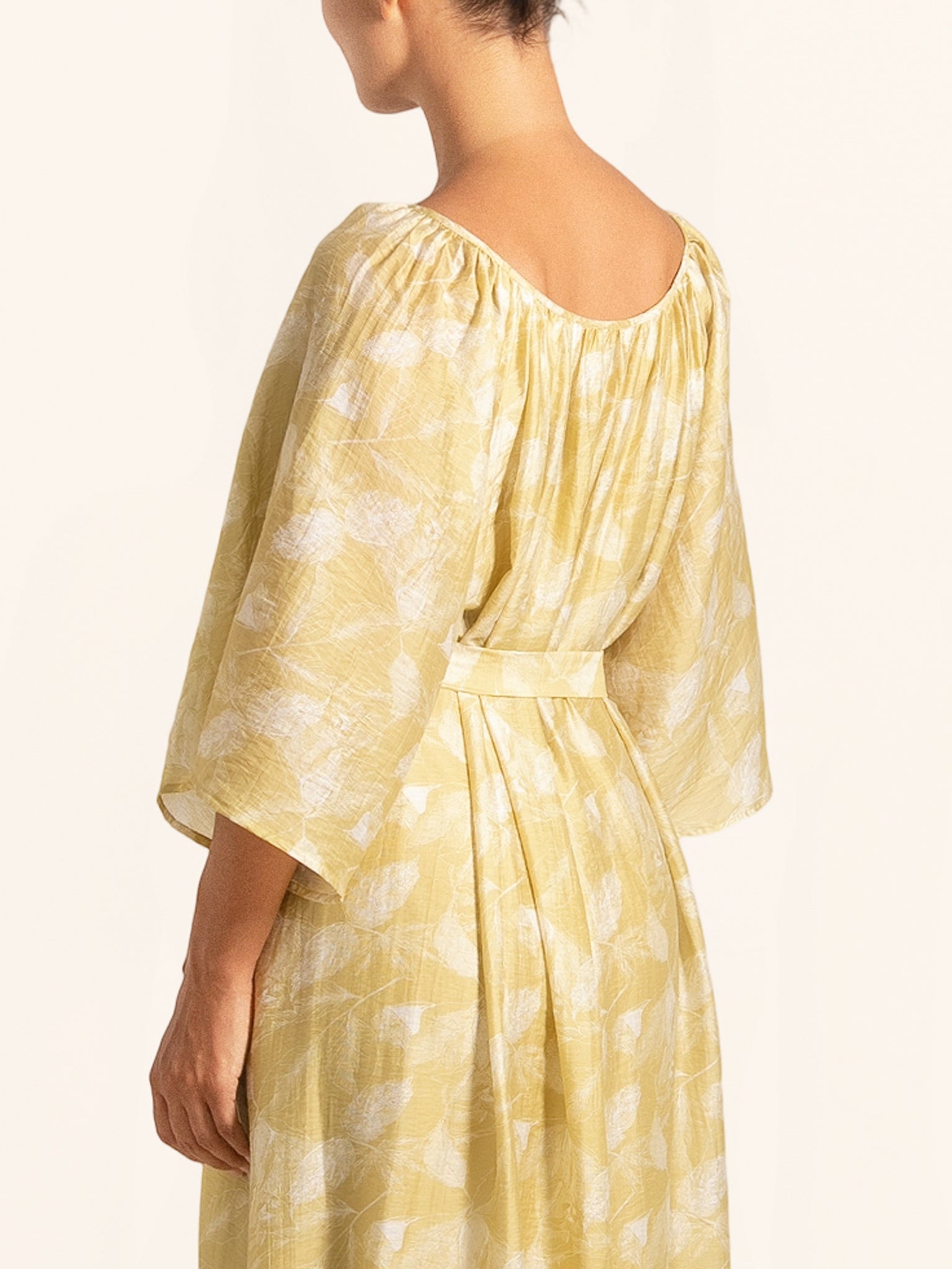 Side profile of mustard yellow maxi dress with wide sleeves
