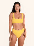Textured swimwear top in mustard yellow with wide shoulder straps.
