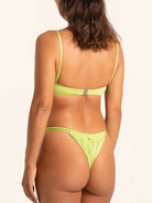 Neon green swim top with crisscross adjustable straps.