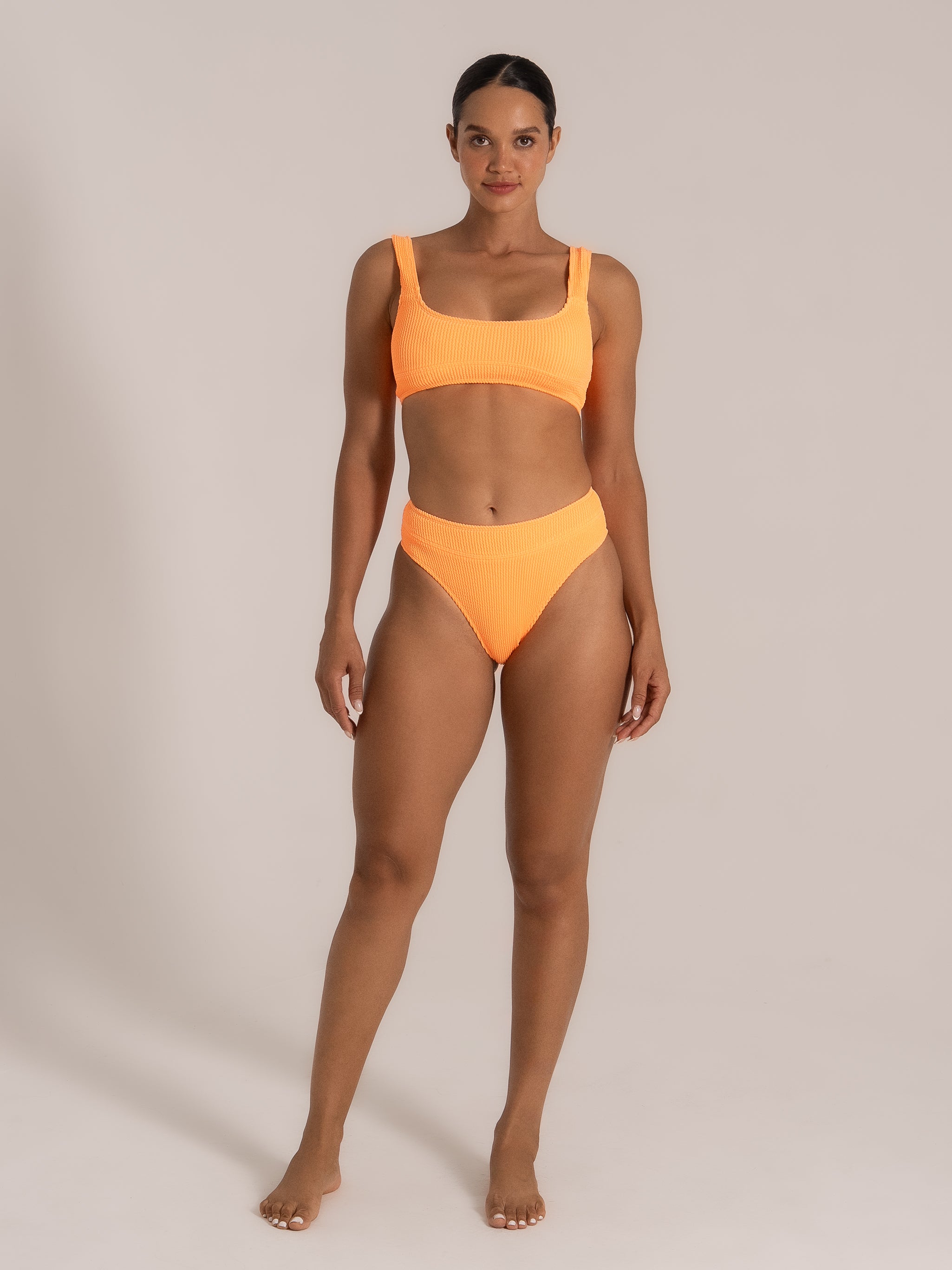 Front view of a neon orange high-waisted bikini set with scoop neck top.