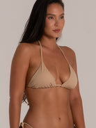 Side angle of triangle halter bikini top in nude shade with soft texture