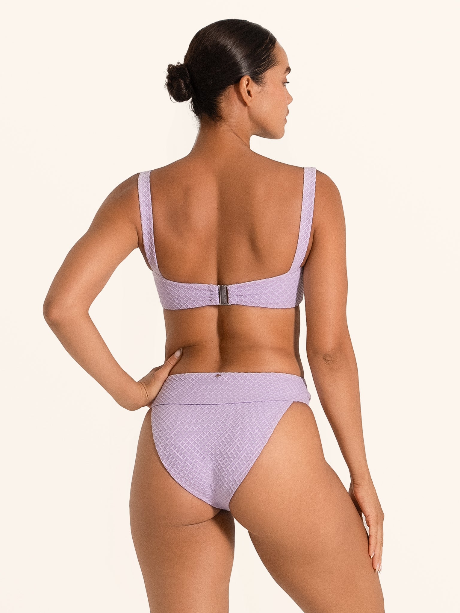 Back view of Ocean Mystery lilac bikini bottom featuring textured finish and mid coverage.