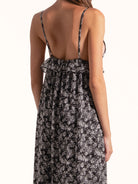 Back view of Ocean Mystery black and white floral maxi dress with open back and relaxed fit.