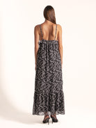 Ocean Mystery black and white floral maxi dress showing adjustable spaghetti straps and tiered hem.