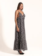 Side profile of Ocean Mystery black and white floral maxi dress with soft fabric and low back design.