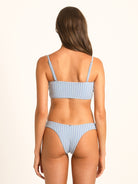 Model wearing Ocean Mystery blue gingham bow tie bikini top in textured stretch fabric with modern shape.