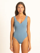 Ocean Mystery blue one piece swimsuit with deep V neckline, front view.