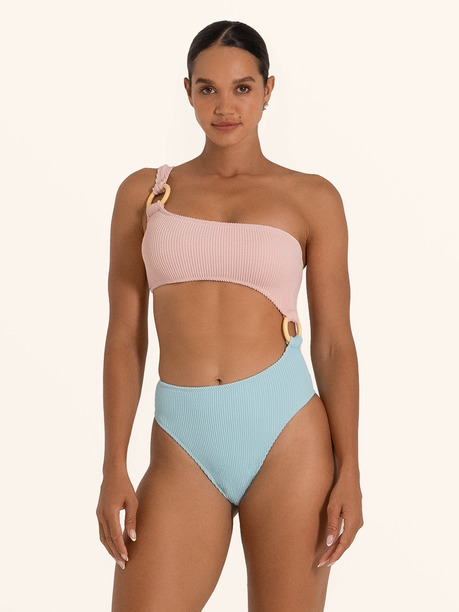 Front view of Ocean Mystery pink and blue one shoulder cut out swimsuit with ring detail