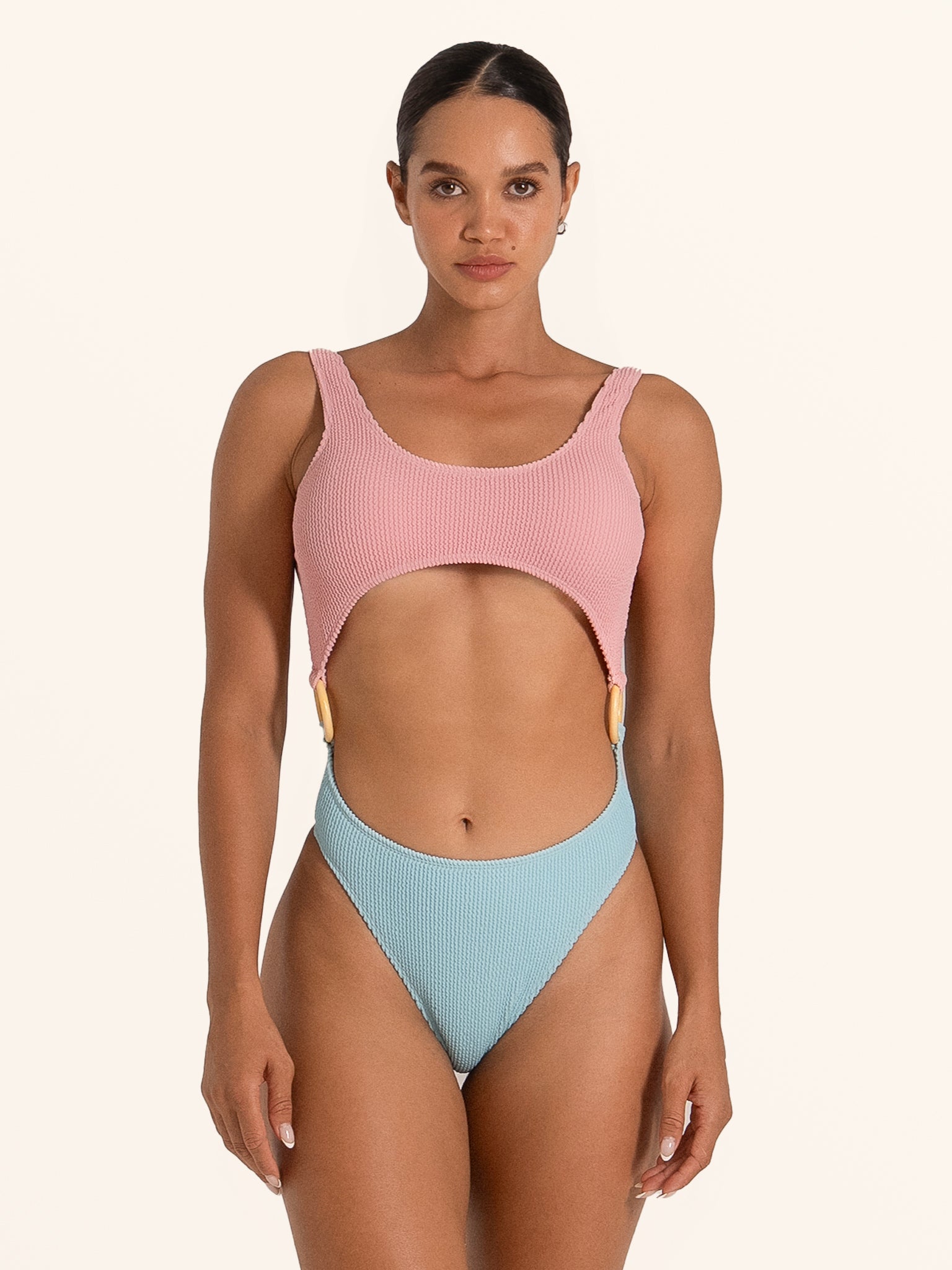 Rear look of Ocean Mystery pink and light blue cut out one piece swimsuit with ring accent