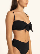 Front view of Ocean Mystery black sweetheart bikini top featuring knotted front design.