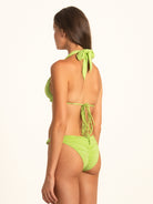 Angled back view of Ocean Mystery green halter triangle bikini top